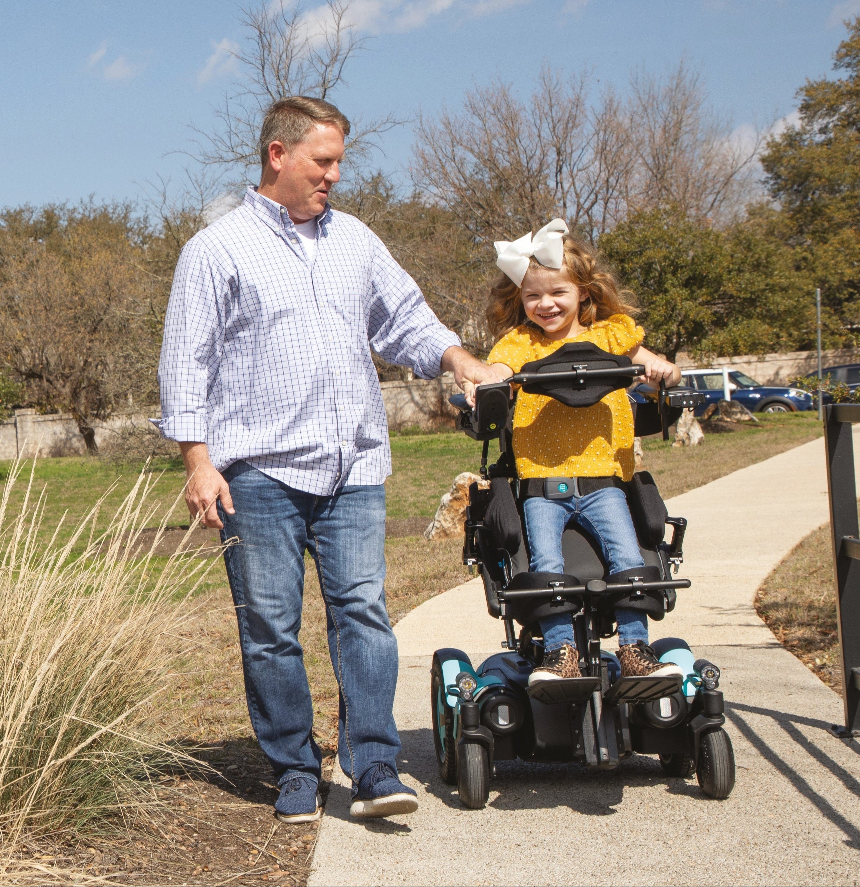 Man and daughter driving in MCorpus VS power wheelchair