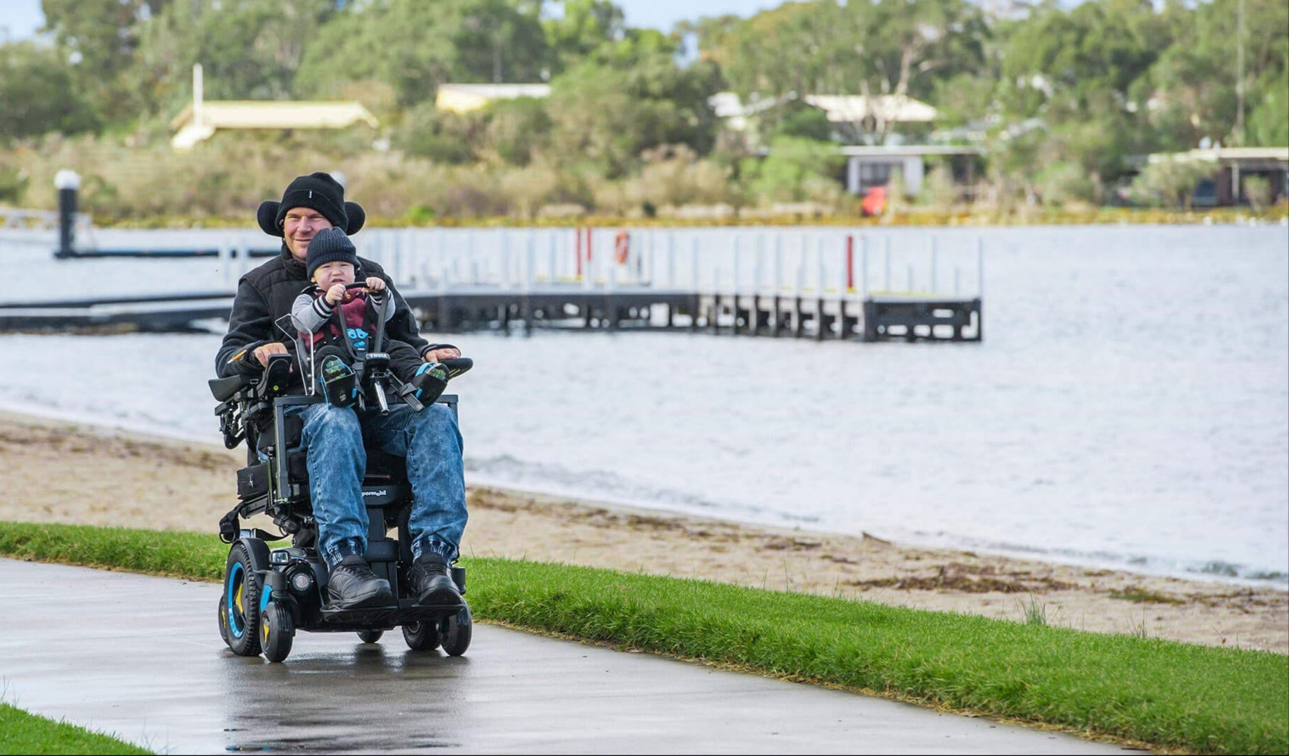 Man with young child in wheelchair