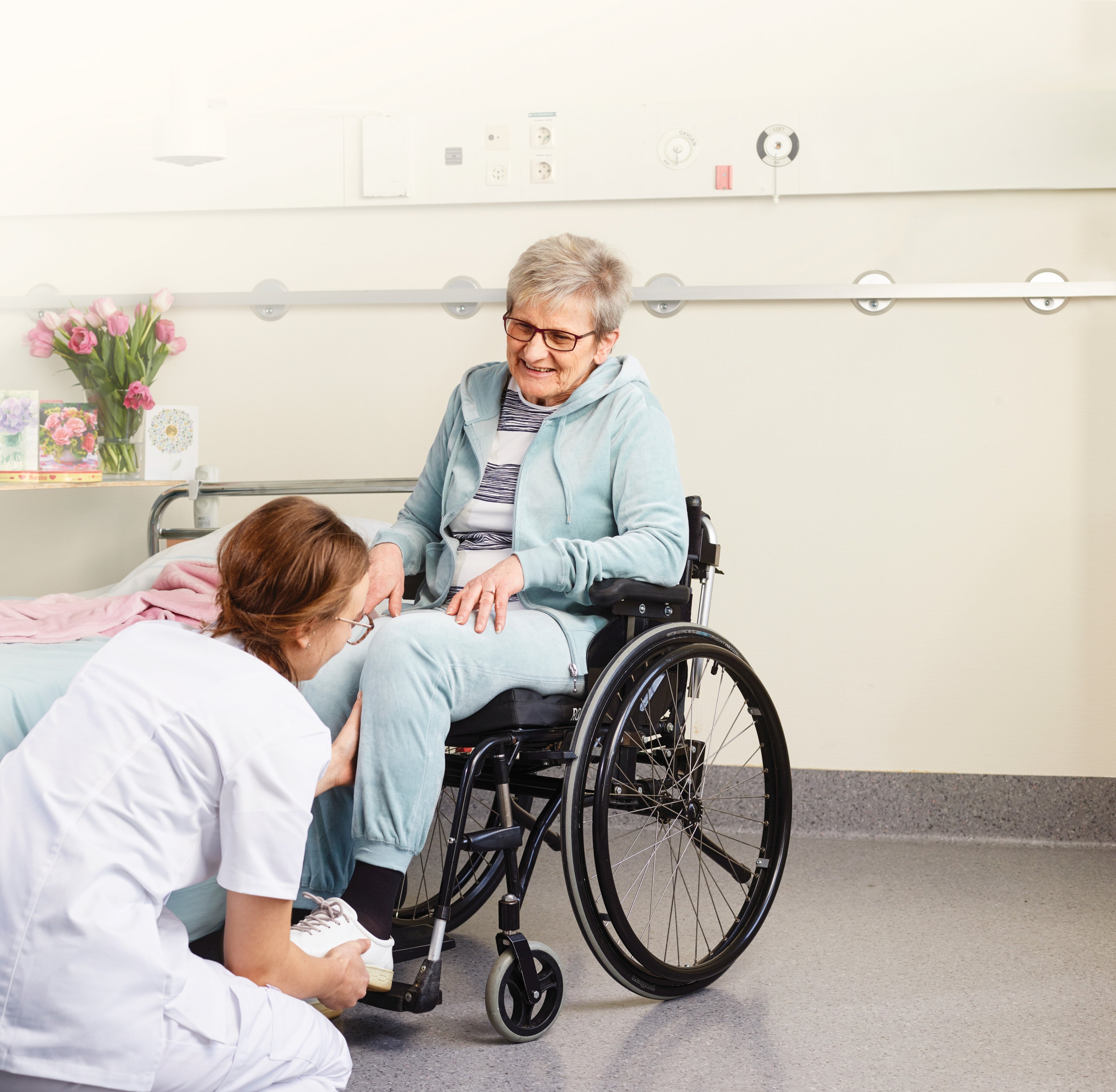 Older woman in Mosaic Manual Wheelchair, adjusted by therapist